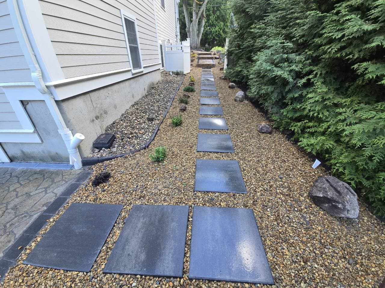 Dark stepping stones along the side of the house in Needham, MA